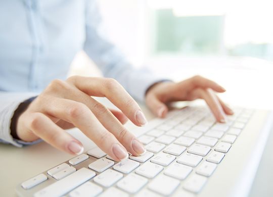 Hands of an office woman typing