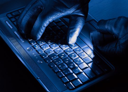 Hands of hacker on a laptop